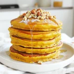 - 1 cup rolled oats - 1 cup canned pumpkin puree - 2 ripe bananas - 2 scoops vanilla protein powder - 1 teaspoon baking powder - 1 teaspoon ground cinnamon - 1/2 teaspoon ground nutmeg - 1/4 teaspoon salt - 1/2 cup almond milk (or milk of choice) - 1 teaspoon vanilla extract - Coconut oil or butter for cooking For this recipe, I like to use rolled oats. They give a nice texture to the pancakes when blended into flour. Canned pumpkin puree adds rich flavor and moisture. Ripe bananas bring natural sweetness and help bind the batter. Protein powder is key for adding protein to your meal. I recommend vanilla flavor as it pairs well with pumpkin spices. Baking powder helps the pancakes rise. Cinnamon and nutmeg give the pancakes warm, cozy flavors. Salt balances the sweetness perfectly. Almond milk or any milk you prefer keeps the batter smooth. Finally, coconut oil or butter prevents sticking and adds flavor while cooking. - High protein content - Fiber from oats and pumpkin - Vitamins and minerals in pumpkin and bananas These pancakes are not just tasty; they are also good for you. The protein powder boosts your energy and helps build muscles. Oats and pumpkin provide fiber, which aids digestion. Pumpkin and bananas are packed with vitamins. Pumpkin is high in vitamin A, which is great for your eyes. Bananas add potassium, good for heart health. Each bite gives you the energy you need for the day. - Substitutions for dairy and gluten-free options - Different protein powder options (plant-based, whey) If you need dairy-free pancakes, use almond or oat milk. For a gluten-free option, make sure to use certified gluten-free oats. You can also try different protein powders. Plant-based options are available if you prefer vegan. Whey protein works well too, as it mixes easily. Experiment with flavors to find what you like best! Start your pancake journey by taking 1 cup of rolled oats. Place them in a blender or food processor. Blend until they turn into a fine, flour-like texture. This oat flour adds a nutty taste and helps bind your pancakes. Make sure it is smooth to get the best results. Now, it’s time to mix the batter. Add the following ingredients into the blender with the oat flour: - 1 cup canned pumpkin puree - 2 ripe bananas - 2 scoops vanilla protein powder - 1 teaspoon baking powder - 1 teaspoon ground cinnamon - 1/2 teaspoon ground nutmeg - 1/4 teaspoon salt - 1/2 cup almond milk (or milk of choice) - 1 teaspoon vanilla extract Blend everything together until it is smooth. The mixture should be thick yet pourable. If it’s too thick, add a bit more almond milk. The thicker texture will help the pancakes stay fluffy. Next, let’s cook these delicious pancakes. Preheat a non-stick skillet over medium heat. Grease it lightly with coconut oil or butter to keep pancakes from sticking. Use a ladle to pour the batter onto the skillet. Cook until you see bubbles forming on the surface, which takes about 3-4 minutes. Once you see those bubbles, carefully flip the pancake over. Cook for an additional 2-3 minutes until both sides are golden brown. Repeat this with the remaining batter, adding more oil as needed. Enjoy your time cooking! To get the best pancakes, monitor your heat closely. Too high, and they burn; too low, and they won’t cook right. I recommend starting with medium heat. If you see smoke, lower the heat. You’ll know it’s time to flip your pancake when bubbles form on the surface. This usually takes about 3-4 minutes. Once you see those bubbles, flip it over and let it cook for another 2-3 minutes until golden brown. Pumpkin protein pancakes taste great with many toppings. Drizzle maple syrup on top for sweetness. You can also add sliced bananas or chopped nuts for extra texture. For a fun presentation, stack the pancakes high. Drizzle with syrup, then sprinkle nuts and a dash of cinnamon on top. This makes your dish look inviting and delicious. If you have leftover pancakes, store them in an airtight container. They can last in the fridge for up to 3 days. Make sure they cool down before sealing to prevent moisture. When you’re ready to eat them, you can reheat pancakes in several ways. The microwave is quick but may make them rubbery. Use a skillet for a crispy edge, or the oven to warm several at once without drying them out. {{image_4}} You can add fun flavors to your pumpkin protein pancakes. Here are some ideas: - Chocolate Chips: Mix in a handful for a sweet twist. - Nuts: Walnuts or pecans add crunch and healthy fats. - Spices: Try ginger or cloves for more warmth and flavor. If you prefer fresh pumpkin, you can use it instead of canned. Just roast or steam the pumpkin, then mash it. Fresh pumpkin brings a bright taste and a lovely texture to the pancakes. You can easily make these pancakes vegan. Substitute the eggs with flaxseed meal. Use a plant-based protein powder and almond milk. This keeps the taste while making it vegan-friendly. For a high-fiber option, add more oats or flaxseed meal. This boosts fiber and keeps you feeling full longer. It’s a great way to add nutrition without changing the flavor much. Try making pumpkin protein pancake muffins. Just pour the batter into a muffin tin. Bake at 350°F for about 20 minutes. You’ll get soft and fluffy muffins. You can also create waffles with the pancake batter. Just pour it into a preheated waffle maker. Cook according to the maker’s instructions. The result is crispy on the outside and fluffy inside. Enjoy these fun twists on classic pancakes! You can keep your pumpkin protein pancakes in the fridge for up to five days. Store them in an airtight container. This keeps them fresh and safe to eat. To freeze pancakes, stack them with a piece of parchment paper in between. Place them in a freezer bag or container. Make sure to remove as much air as possible. This helps prevent freezer burn. Thaw them overnight in the fridge for the best results. You can reheat pancakes in three ways: - Microwave: Place pancakes on a plate. Heat for 30 seconds to 1 minute. Check that they are warm enough. - Skillet: Preheat a skillet over medium heat. Add a little oil. Cook each pancake for 1-2 minutes on each side. - Oven: Preheat the oven to 350°F (175°C). Place pancakes on a baking sheet. Cover with foil and heat for about 10 minutes. These methods help keep your pancakes tasty and ready to enjoy. To make your pancakes fluffier, add some extra air to the batter. Here are some tips: - Use fresh baking powder. Make sure it's not expired for best results. - Separate the eggs. Whip the egg whites until they are stiff, then fold them in. - Don’t over-mix. Mix just until combined; lumps are okay. - Let the batter rest. Allow it to sit for 5-10 minutes before cooking. This helps the gluten relax. Yes, you can use other flours! Here are some options: - Almond flour. This adds a nutty flavor and works well for gluten-free diets. - Whole wheat flour. This adds more fiber and nutrients. - All-purpose flour. This is an easy swap and gives a classic pancake taste. Each type of flour can change the texture, so try them out to see what you like best. The best protein powder for pancakes can vary. Here are some recommendations: - Whey protein. This mixes easily and gives a smooth texture. - Pea protein. Great for vegans and adds a mild flavor. - Soy protein. This is also plant-based and packs a protein punch. Choose a flavor that matches well with pumpkin, like vanilla or cinnamon for the best taste. These pumpkin protein pancakes are easy to make and healthy. We covered the essential ingredients, benefits, and tasty options. I shared step-by-step instructions and tips for perfect pancakes. You can even try different flavors and variations. Incorporating these pancakes into your meals can boost your nutrition. Enjoy the fun of cooking and experimenting with this recipe in your kitchen.